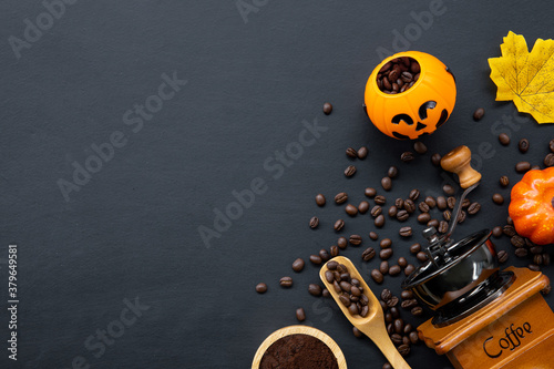 halloween decoration with hot coffee and beans on dark background. flat lay. Copy space for text.