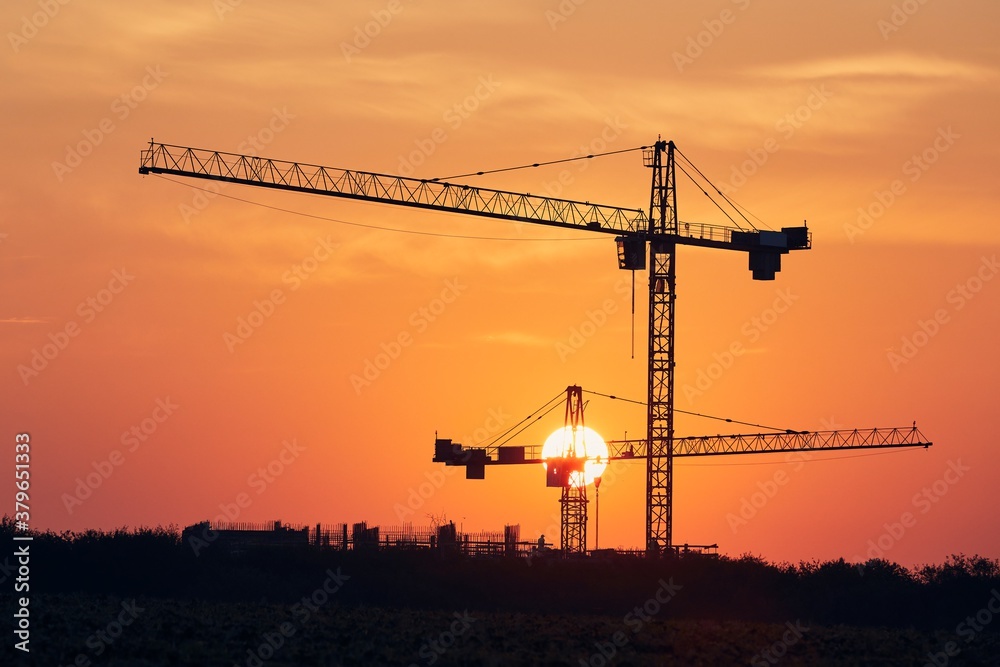 Building activity on contruction site at sunrise