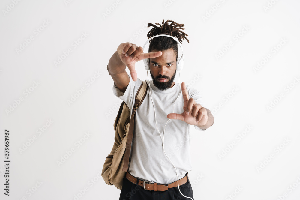 Photo of serious african american guy showing frame gesture