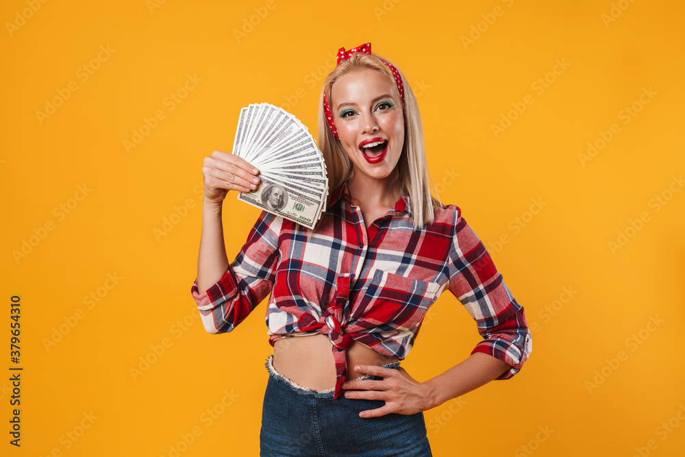 Image of cheerful blonde pinup girl posing with dollars Image of cheerful blonde pinup girl posing with dollars
