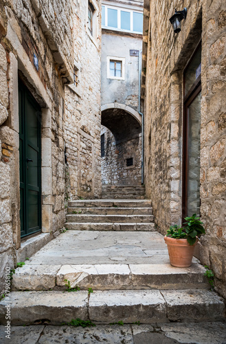 Medieval narrow street with a turn in Sibenik  Croatia