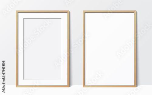 Set of 2 simple wooden frames leaning against the white wall. Blank elegant frame template. Picture frame vector mockup.