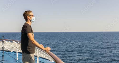 Portrait of man Traveling by Ferry Boat During Covid 19, Wearing Mask and Enjoying the Beautiful View. © Sofia ZA