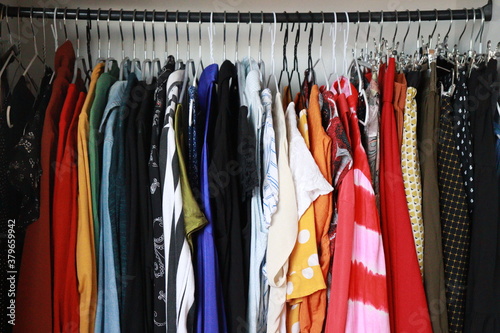 colorful clothes on hangers in a wardrobe