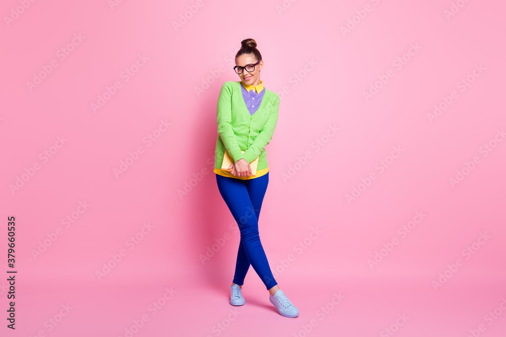 Full size photo of clever intelligent high school student girl hold book enjoy study academic university wear green bright outfit isolated over pastel color background Full size photo of clever intelligent high school student girl hold book enjoy study academic university wear green bright outfit isolated over pastel color background