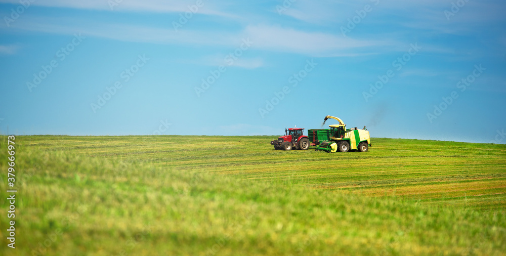 Agriculture. Mowing meadows. Technology. Farmer mowing his field on the tractor. Agriculture. Mowing meadows. Technology. Farmer mowing his field on the tractor.