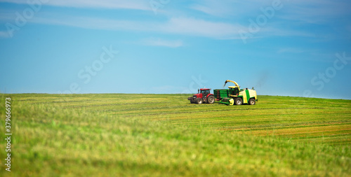 Agriculture. Mowing meadows. Technology. Farmer mowing his field on the tractor.  