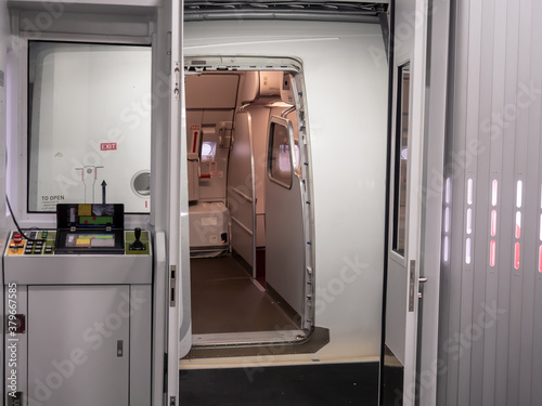 Jetway, walking towards the plane on carpet, seeing the aircraft door and aerobridge controller.