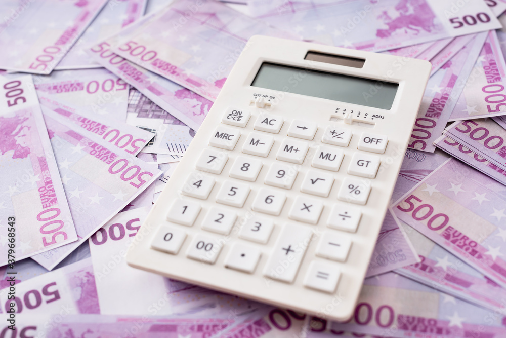 Selective focus of white calculator on euro banknotes Selective focus of white calculator on euro banknotes