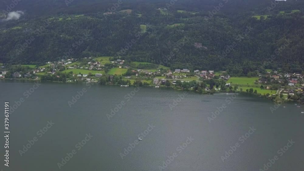 Aerial view on the upper ends of Ossiacher Lake in Carinthia, Austria on a summer day with great cloudscape. Aerial view on the upper ends of Ossiacher Lake in Carinthia, Austria on a summer day with great cloudscape.