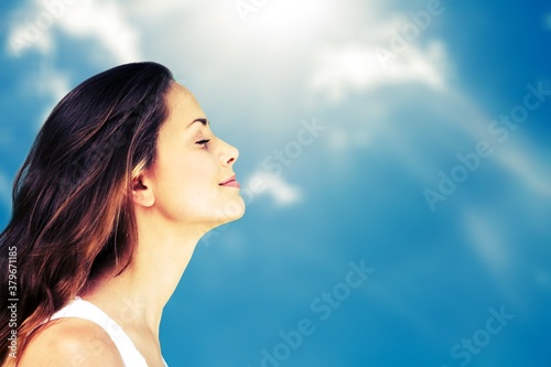 Happy young woman with perfect skin on outdoor background