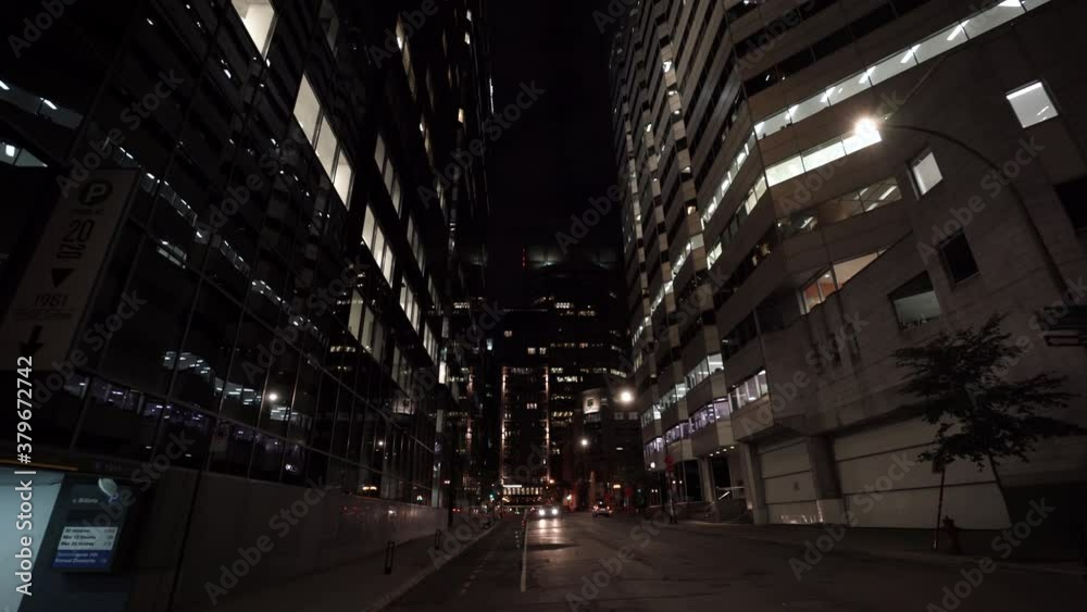 Few Cars Travelling By High Street At Night During The Coronavirus Pandemic In Montreal, Quebec, Canada - Long Shot Few Cars Travelling By High Street At Night During The Coronavirus Pandemic In Montreal, Quebec, Canada - Long Shot