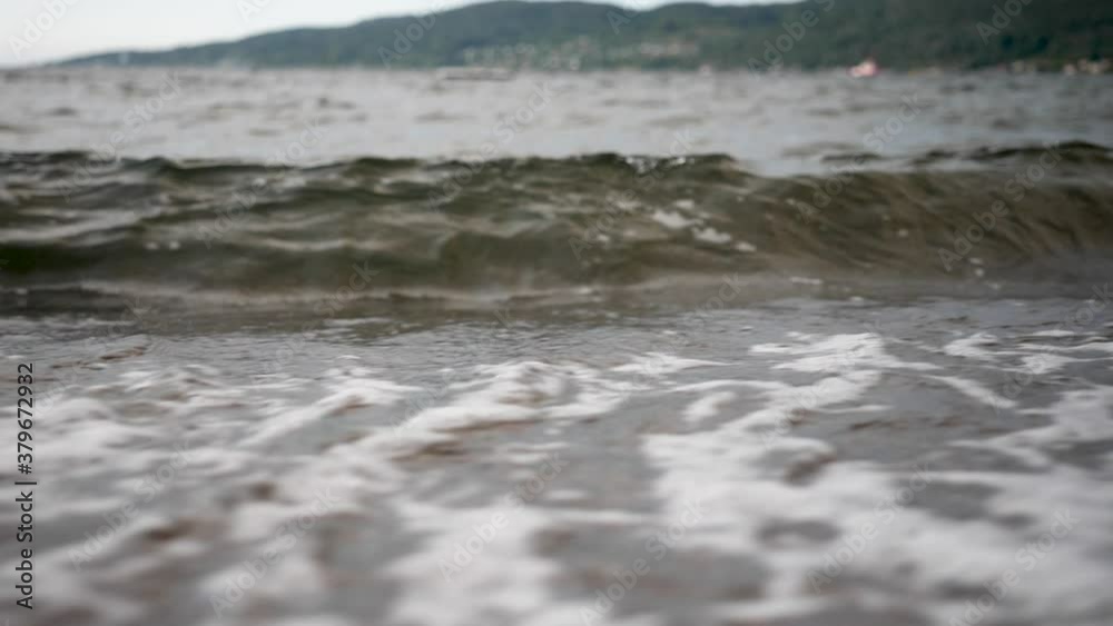 Isolated static view of ocean waves gently rolling in to a foamy shore Isolated static view of ocean waves gently rolling in to a foamy shore