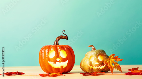 Halloween pumpkins on a table over a blue background