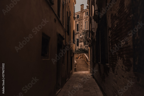 Architecture and landmarks of Venice  Italy. Ancient brick and beige buildings  narrow streets between the houses  tiled roofs.