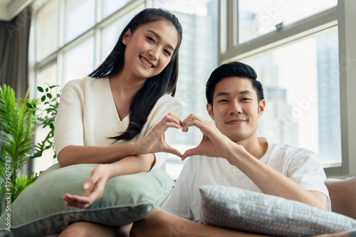 Attractive young Asian couple in the living room, Happy young man and woman in casual lifestyle. Lovely wife and husbands relationship.