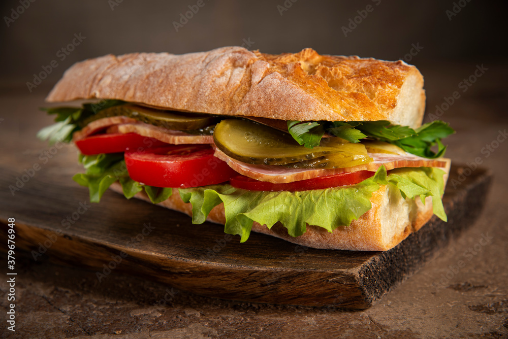 Sandwich with homemade bread, ham, tomatoes, lettuce and pickled cucumber Sandwich with homemade bread, ham, tomatoes, lettuce and pickled cucumber