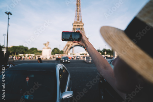 Female tourist taking pictures from road