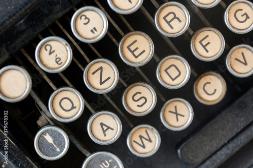 close-up view from above of the dusty keys of an old typewriter. Old mechanical tool for writing. Journalism and storytelling © rarrarorro