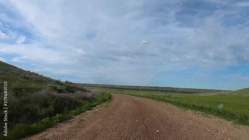 HYPER LAPSE - Traveling down a dirt road in the country on a cloudy day with a blue sky. HYPER LAPSE - Traveling down a dirt road in the country on a cloudy day with a blue sky.