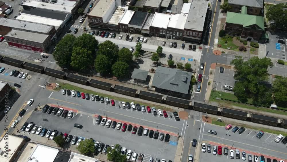 Time lapse of a train moving through a small towns downtown area. Time lapse of a train moving through a small towns downtown area.