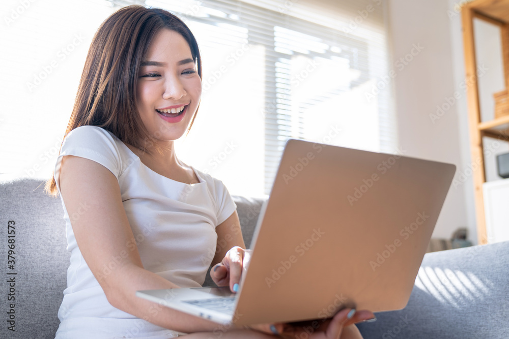 Beautiful Asian woman working on laptop computer while sitting at the home, Work from home. Beautiful Asian woman working on laptop computer while sitting at the home, Work from home.