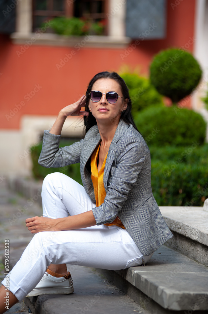 Fototapeta premium Young beautiful woman dressed in casual style in the city