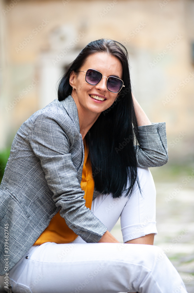 Young beautiful woman in sunglasses in the city