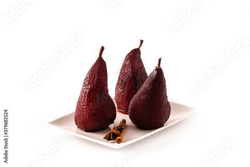 Poached pears in red wine isolated on white background
