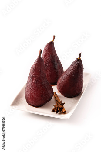 Poached pears in red wine isolated on white background