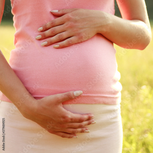 Wallpaper Mural belly of a pregnant woman in nature Torontodigital.ca