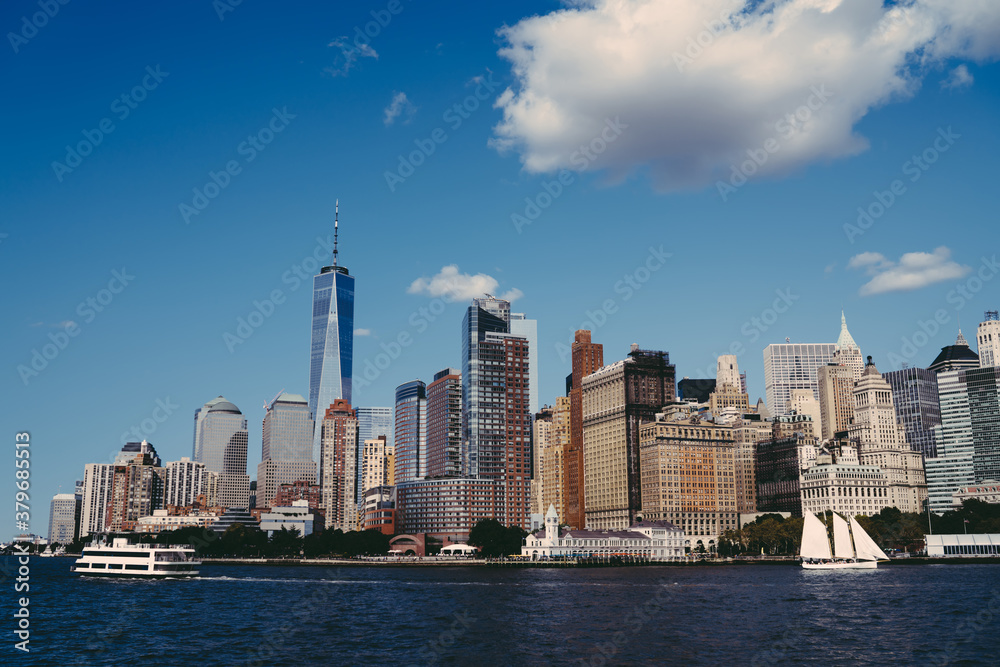 Urban Manhattan skyscrapers on seafront with flowing river