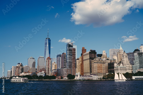 Urban Manhattan skyscrapers on seafront with flowing river © BullRun