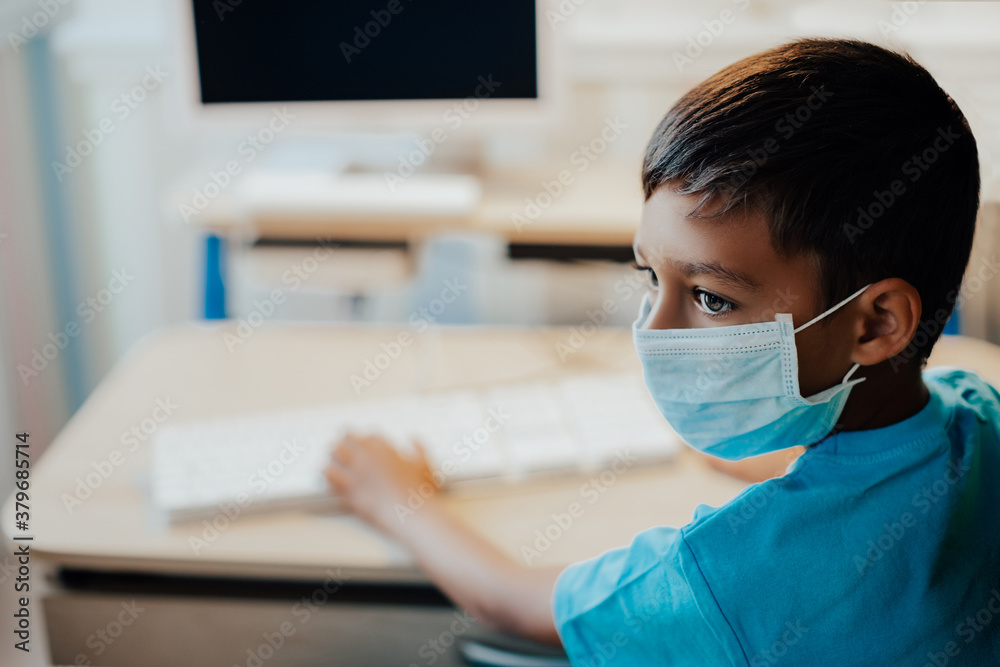 Quarantine training. Boy studies at home, wear protective masks, and doing school homework. Distance learning online education. Quarantine training. Boy studies at home, wear protective masks, and doing school homework. Distance learning online education.