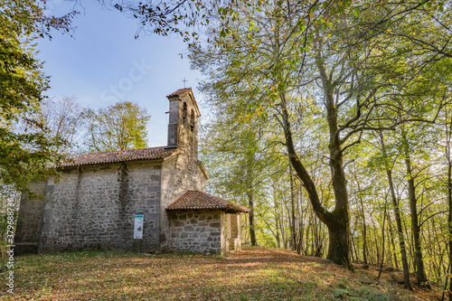 View of small cute Church of the Three Kings in the wood near Castelmonte, Prepotto, Friuli rgion, Italy photo