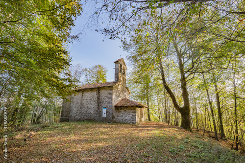 View of small cute Church of the Three Kings in the wood near Castelmonte, Prepotto, Friuli rgion, Italy photo