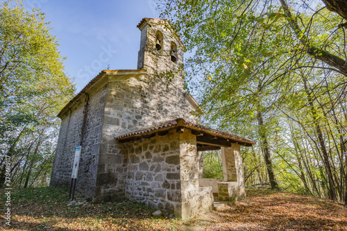 View of small cute Church of the Three Kings in the wood near Castelmonte, Prepotto, Friuli rgion, Italy photo