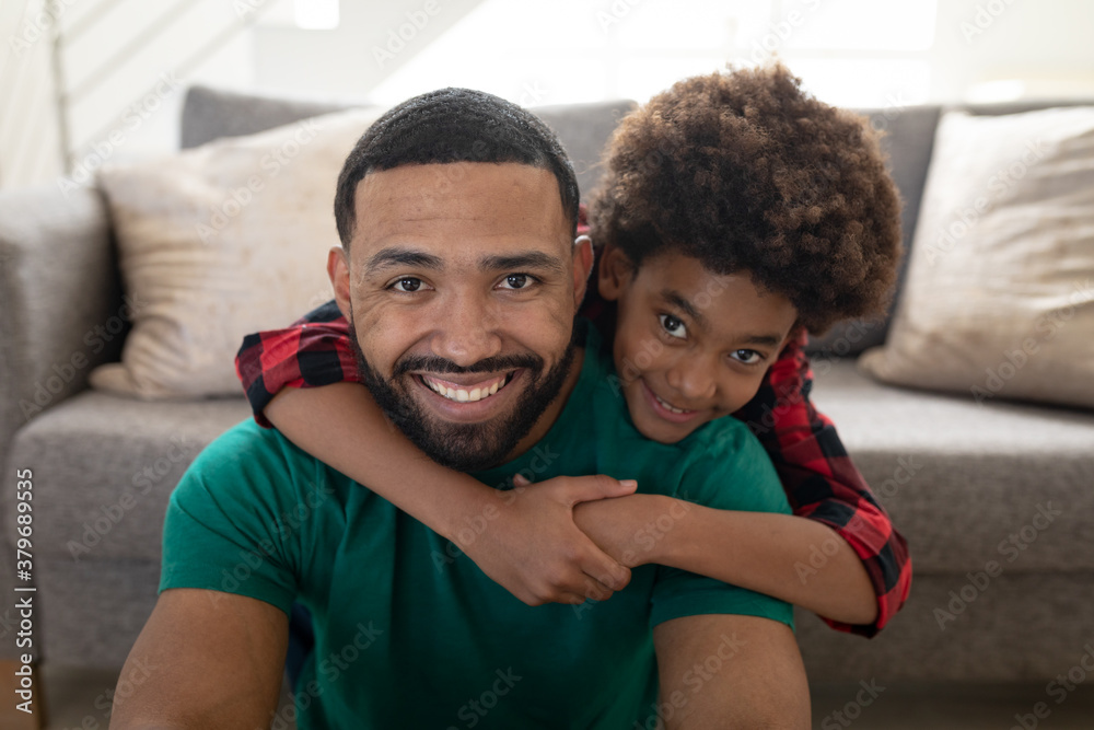 Fototapeta premium Portrait of father and son at home