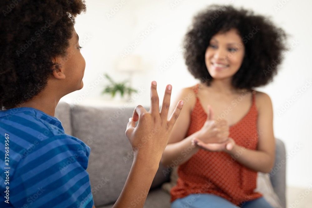 Mother and son communicating with each other in sign language