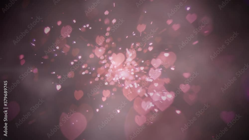 Heart shaped light sparks against pink background Heart shaped light sparks against pink background