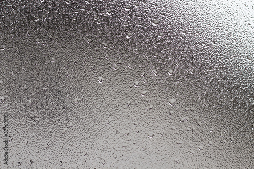 Frosted glass texture photo with blurred background.