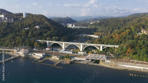 Wallpaper Mural Aerial video shooting. Top view of the bridge. Seaside. Sunset. Sochi. High mountains on the horizon. Viaduct. Overpass. Railway along the seashore. Macesta Torontodigital.ca
