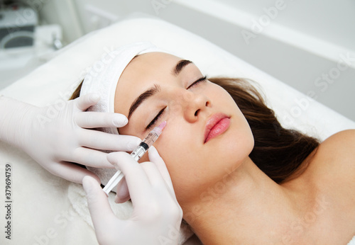 Woman getting cosmetic. injection. Beauty injections and cosmetology. Young woman in beauty salon sloseup