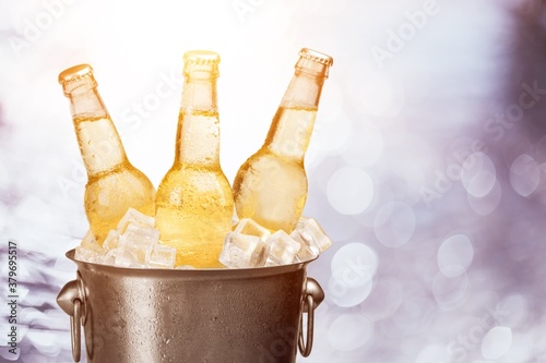 Bottles of cold and fresh beer with ice in the bucket