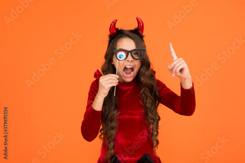 halloween kid in suit and imp hors with spooky party glasses shouting emotionally and raise finger, halloween zombie