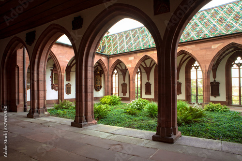 Green plants in inner courtyard of Basel Cathedral. Cloister with archway and inner garden. Switzerland. © MindestensM