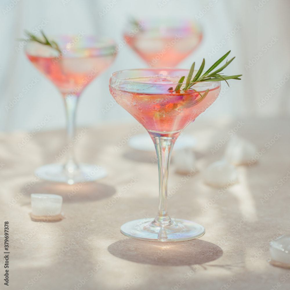 Glass of strawberry soda drink on beige sandy background. Summer healthy detox lemonade, cocktail or another drink background. Nonalcoholic drinks, super food, vegetarian or healthy diet concept.
