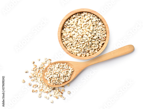 Flat lay (top view) of Job's tears  in wooden bowl and spoon on white background. photo