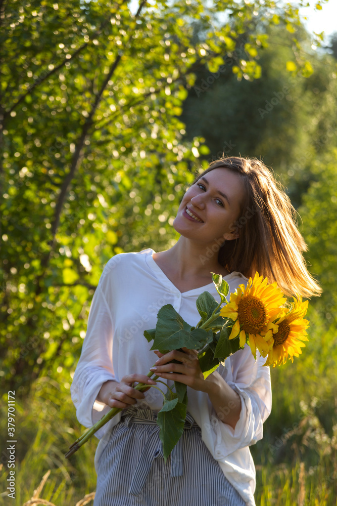 Happy smiling girl with yellow sunflowers Happy smiling girl with yellow sunflowers