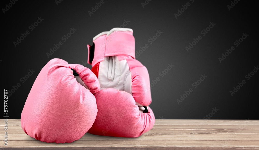 Sport pink boxing gloves on the desk